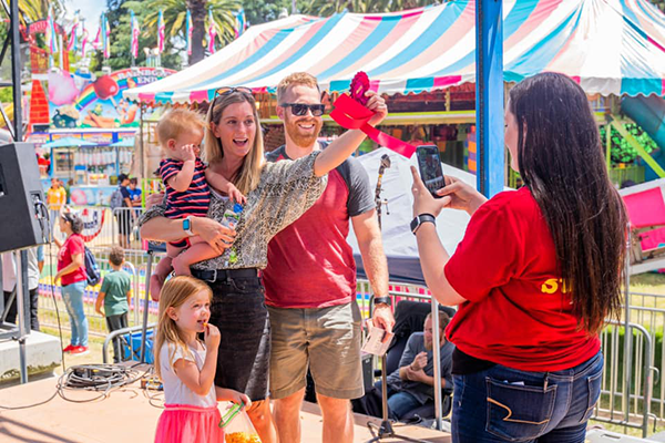 A family of four enjoying a day at the Alameda County Fair.
